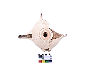 A broken ceramic vessel with a hole  Description automatically generated with medium confidence