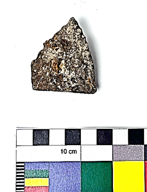 A rock and a small piece of paper  Description automatically generated